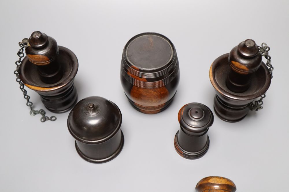 A group of 19th century lignum vitae objects: A pair of whistles and holsters, a match holder with go-to-bed, a model barrel, 9cm, a ga